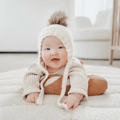 Baby exploring the Little Lamb Kind Tummy Time Baguette
