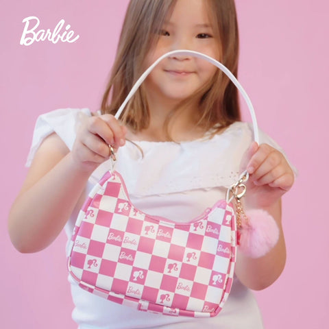 Child holding a pink Zomi Gems Barbie handbag