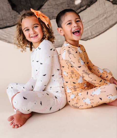 Children wearing matching halloween pajamas with long sleeves