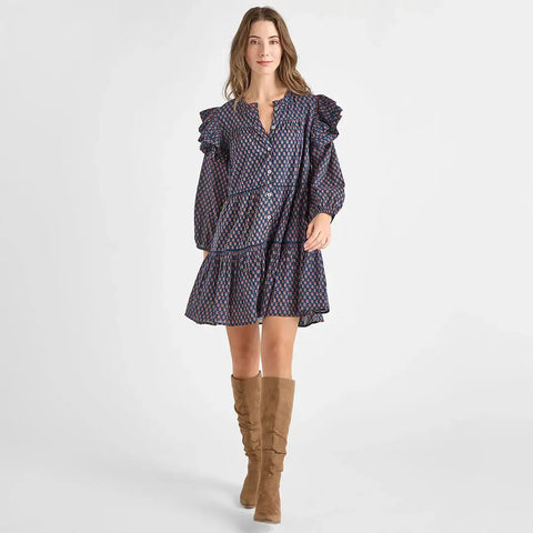 Woman wearing a patterned dress with puffed sleeves and brown knee-high boots on a white background from Pink Chicken