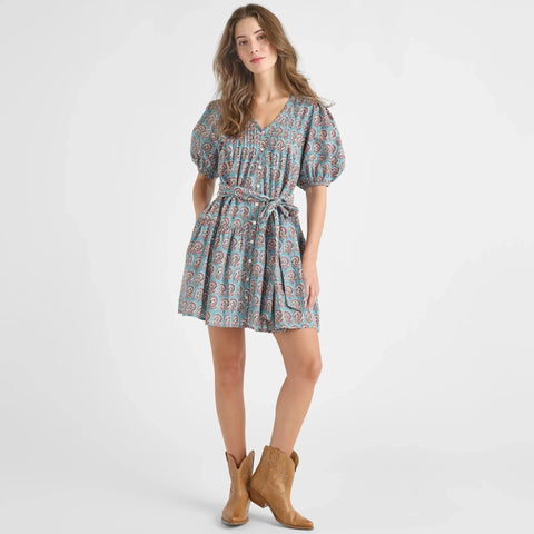 Woman wearing a patterned dress with puff sleeves on a white background from Pink Chicken